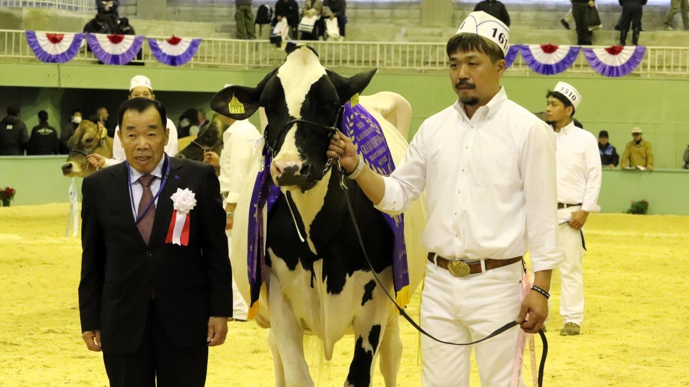 最高位に輝いたマツカチエン号と木村吉里さん（右）、日本ホルスタイン登録協会の前田勉会長
