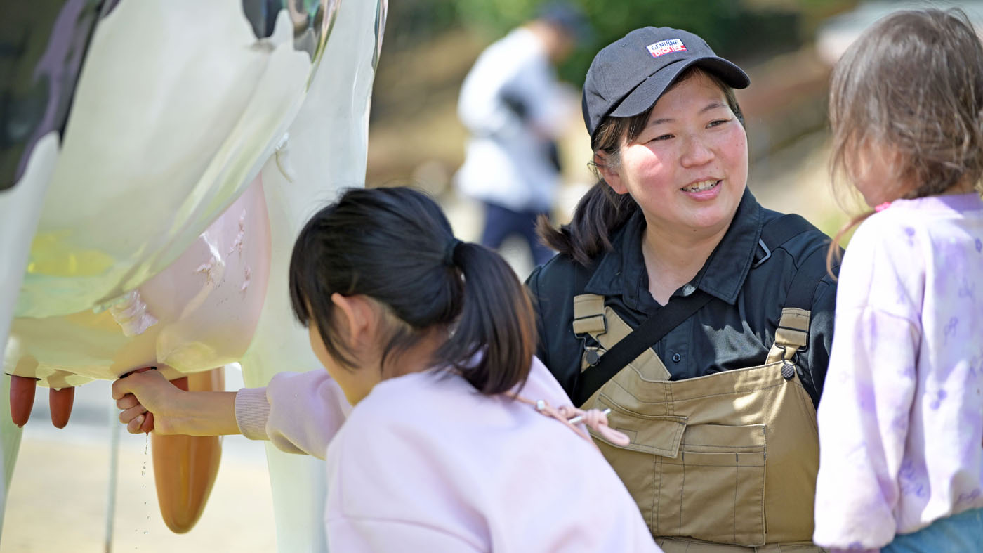 模擬搾乳牛を使った搾乳体験を担当した長﨑清子さん